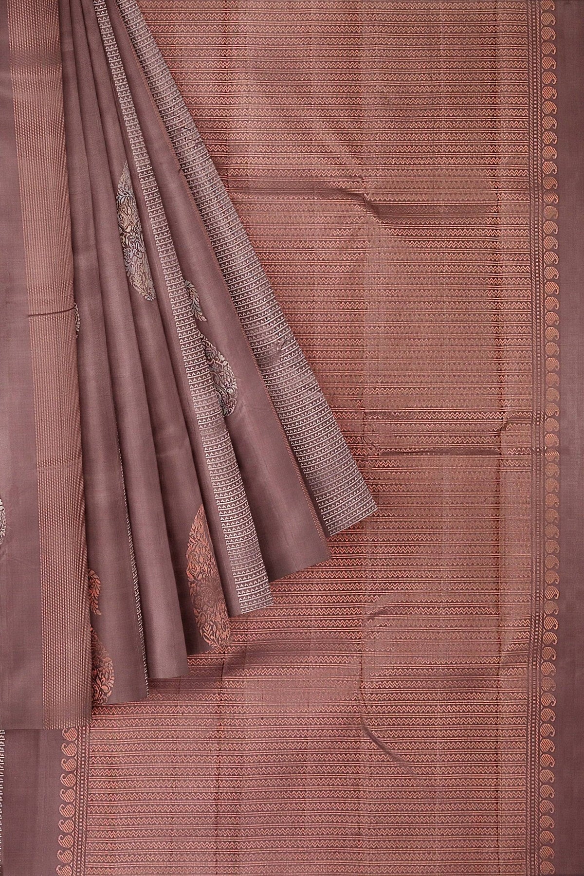 Brown kanchivaram soft silk saree with silver and copper zari in geometrical and paisley motifs.