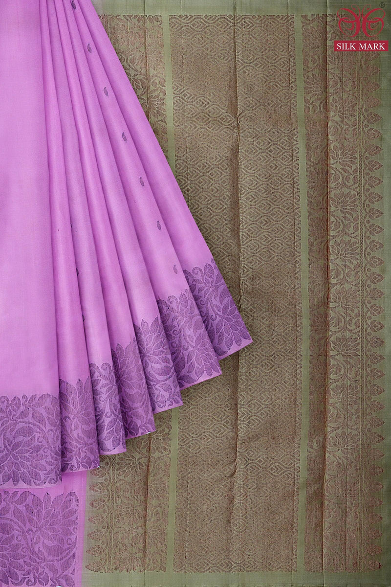 A silk marked Kanchivaram handloom saree with the body in lotus pink and pallu in pastel brown color with floral & mango motifs in neem zari.
