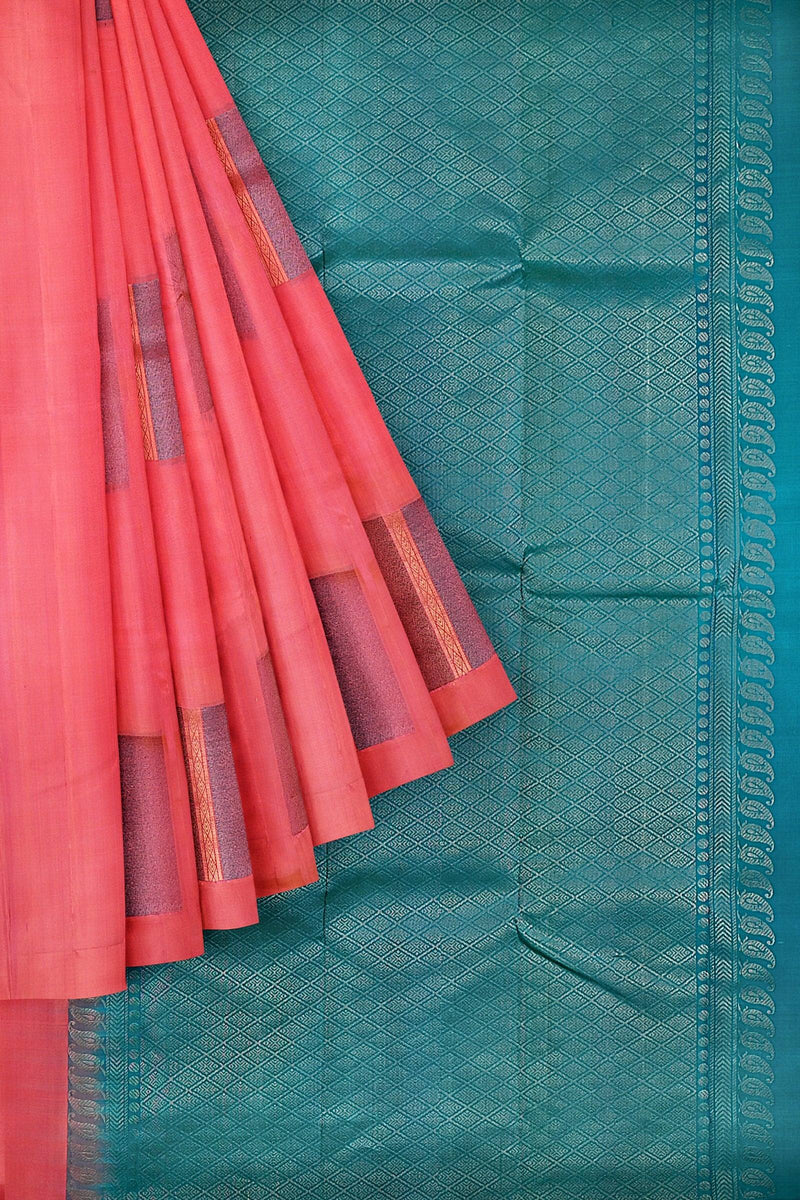 A pure Kanchivaram handloom saree with the body in pastel pink and pallu in teal blue color with glitter motifs in neem zari.