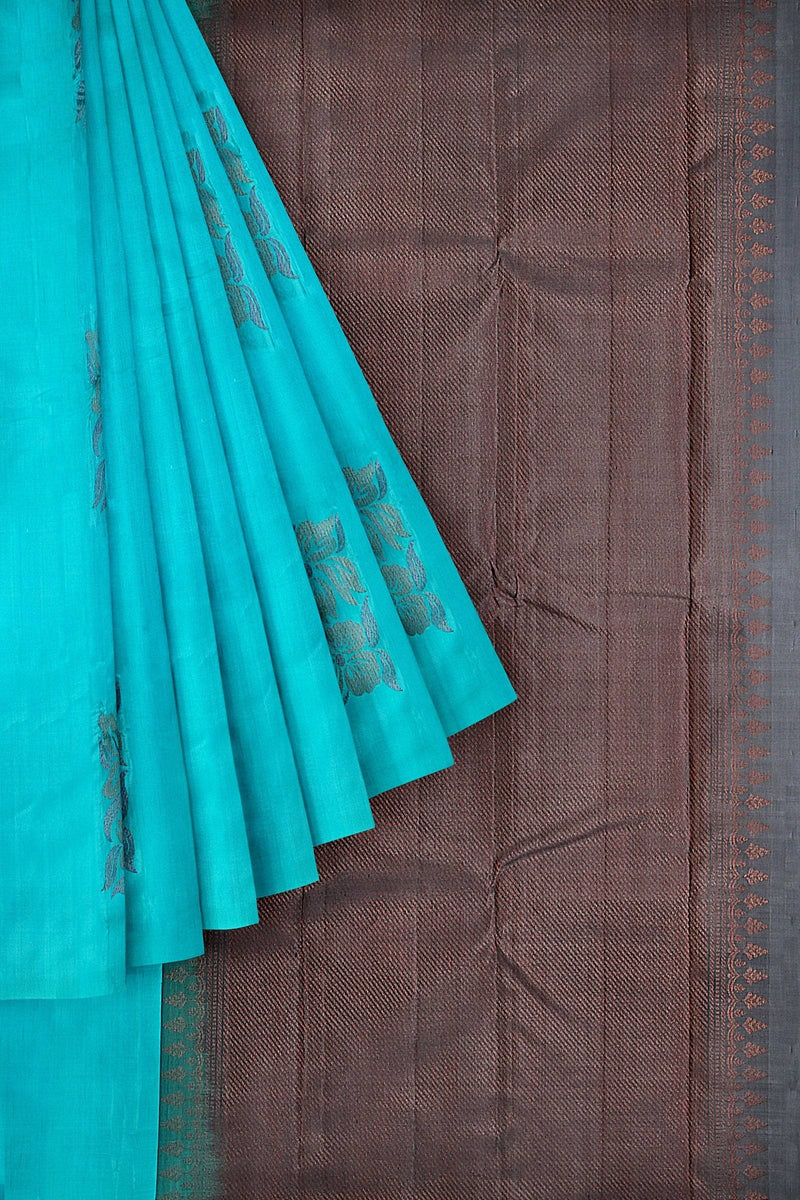 An elegant Kanchivaram handloom saree with the body in sky blue and pallu in copper brown color with floral motifs in neem zari.