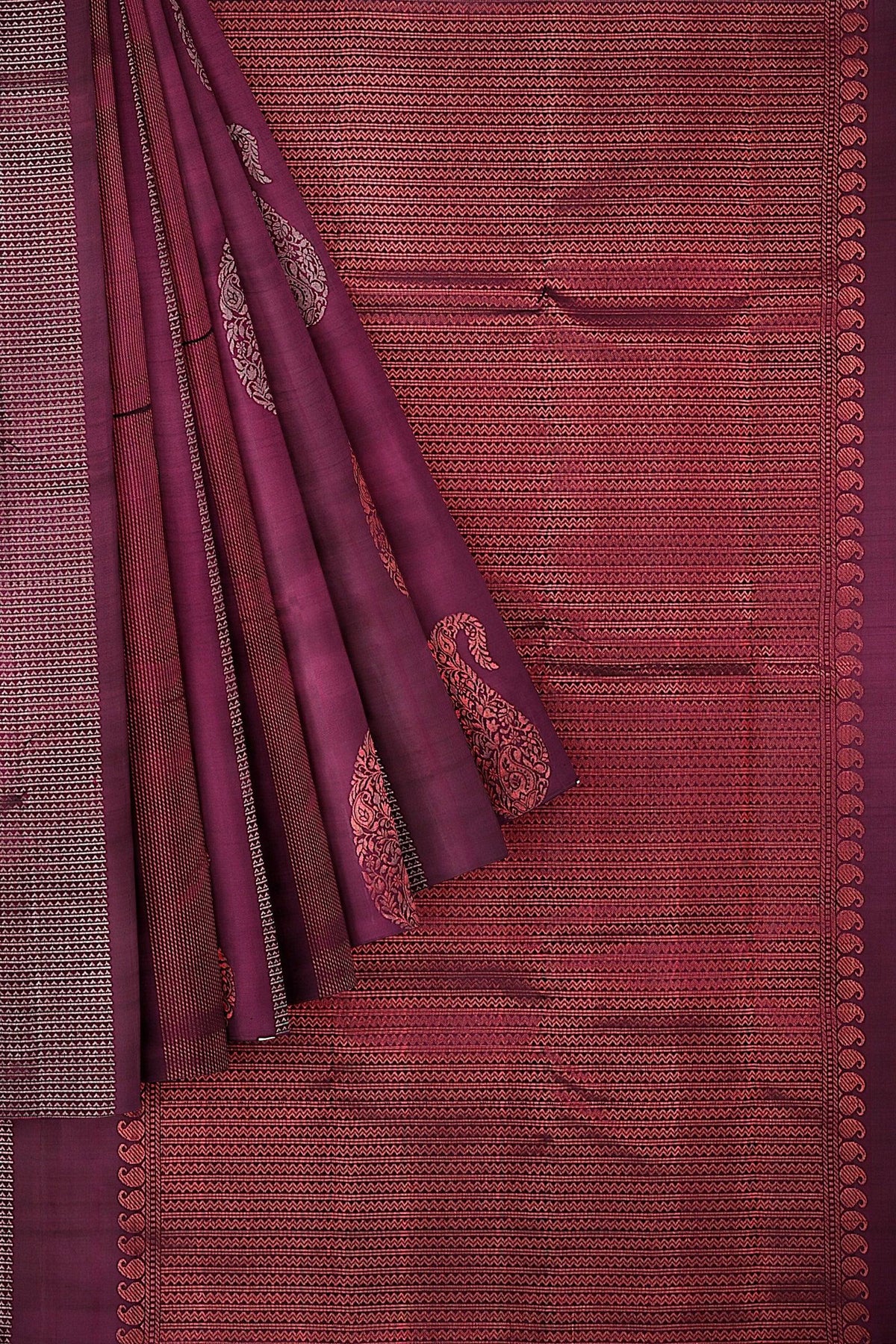 Kanchivaram handloom saree with the body & pallu in maroon with mango & geometrical motifs in silver & copper zari.