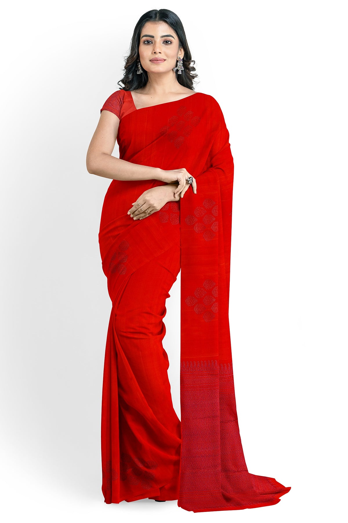 A model draped in a rich red soft silk handloom saree with rich red body and pallu. The saree is designed with floral motifs in purple shaded neem zari works. The saree comes with an attached running blouse material.